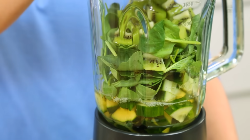 A Blender Filled with A Bright Green Smoothie Mixture