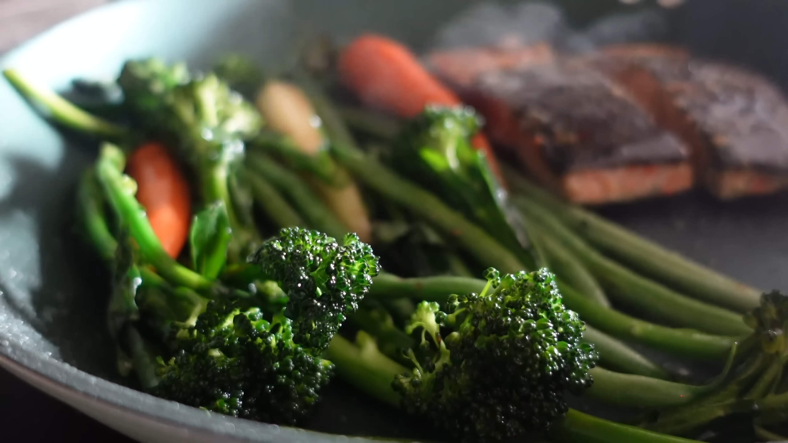 Vegetables and salmon in a pan