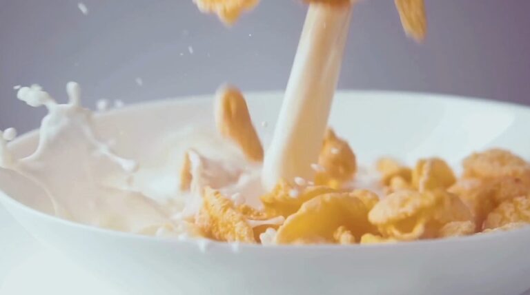 Close up view of cereals in a bowl covered in milk