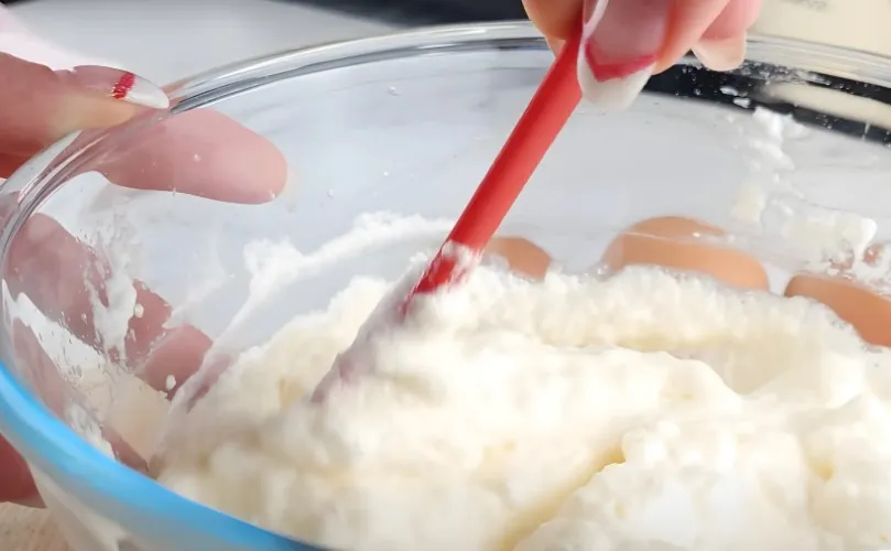 Woman mixing dough in a bowl