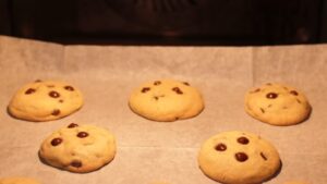 Chocolate Chip Cookies Baking on A Parchment-Lined Tray Inside the Oven