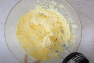 Light and fluffy batter is being mixed in a glass bowl