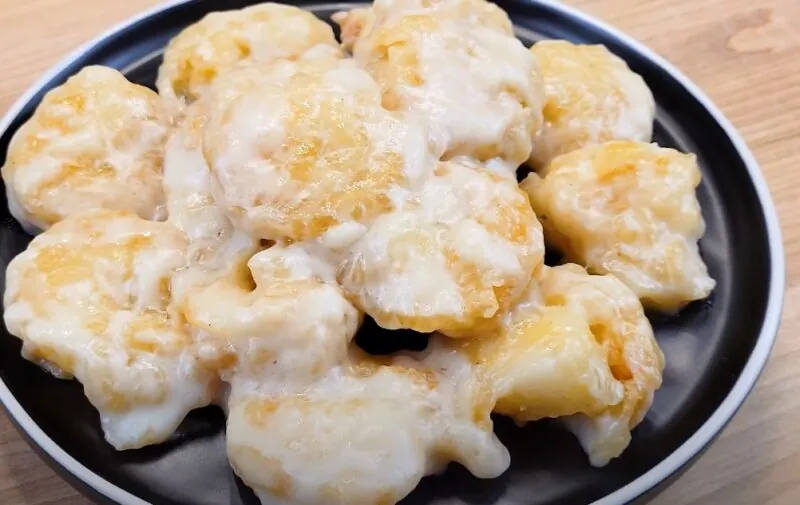 Crispy coconut shrimp, generously coated in a creamy sauce