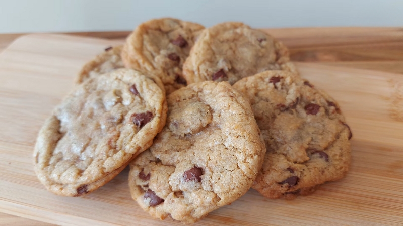 A Close-Up of Freshly Baked Chocolate Chip Cookies on A Wooden Board