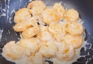 Crispy coconut shrimp, coated in a creamy sauce